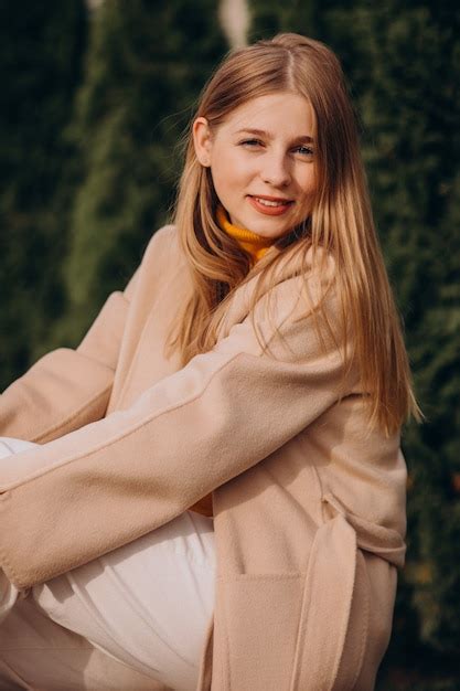 photo young happy woman  beige coat