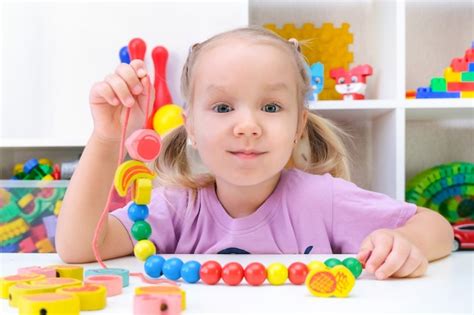 Premium Photo | Speech therapy, the development of fine motor skills. toddler girl is stringing ...