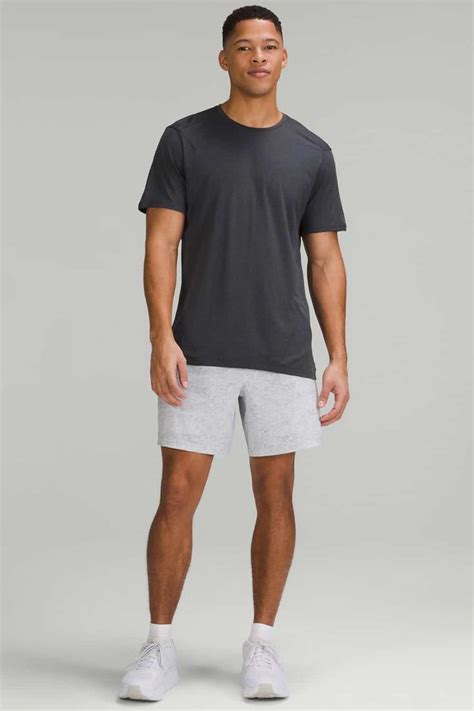Men's grey athletic shorts, black T-shirt, white socks and white ...