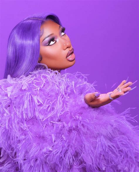 Download Megan Thee Stallion striking a pose in front of a colorful