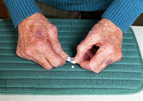 Elderly Woman Popping Pills Photograph by Paul Rapson/science Photo ...