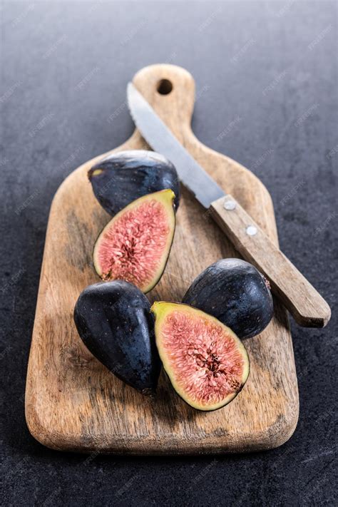 Free Photo | Fresh figs on cutting board on black stone