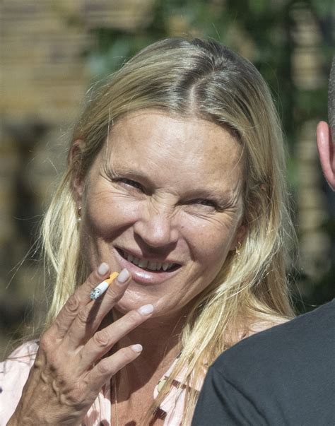 Kate Moss looks unrecognizable while smoking a cigarette during family ...