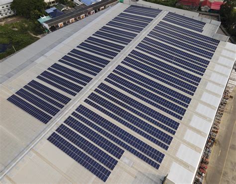 Aerial drone image of solar panels installed on a roof of a large
