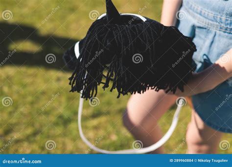 Hobby Horsing Competition on a Green Grass, Hobby Horse Riders Jumping ...