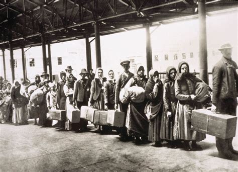 Immigrants at Ellis Island wait for the ferry to take them into New ...