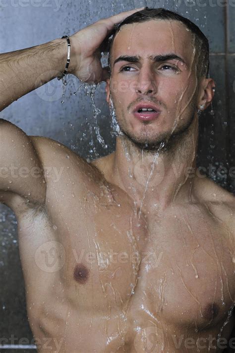 good looking man under man shower 10944994 Stock Photo at Vecteezy