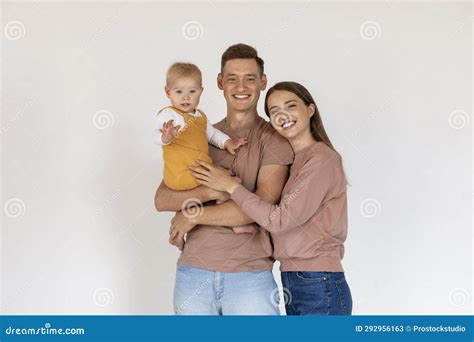 happy young parents holding  cute toddler son  smiling