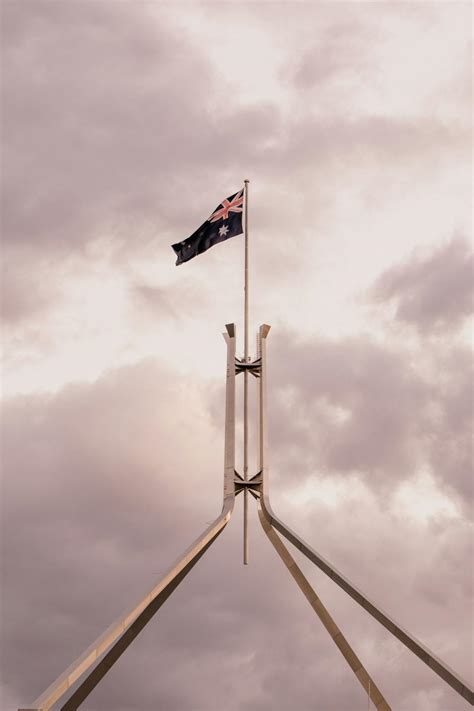 Australian flag flying over parliament house · Free Stock Photo