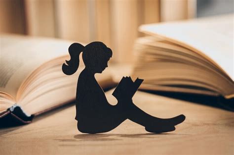 Premium Photo | Silhouette of a girl reading a book in the library