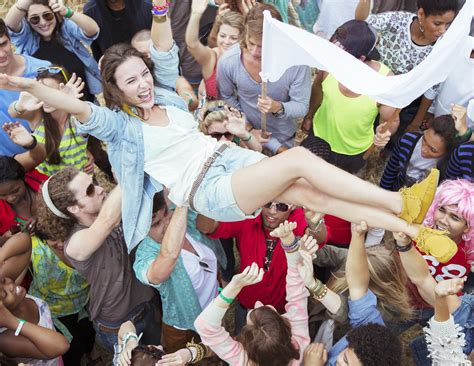 Woman crowd surfing at music festival | Music festival, Festival, Women