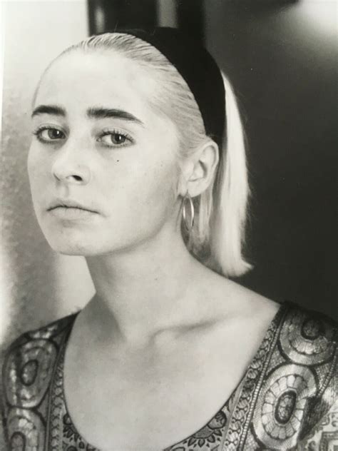a black and white photo of a woman with blonde hair wearing a headband