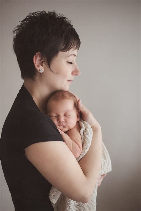 "Mother Holding Tight Her Newborn Baby" by Stocksy Contributor "Lea