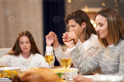 Beautiful family praying over festive dinner at home 15770528 Stock Photo at Vecteezy