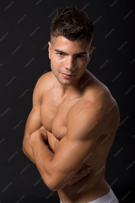 Premium Photo | Handsome muscular young man posing in the studio