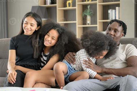 Asian-African American family relaxing, chatting, painting and having
