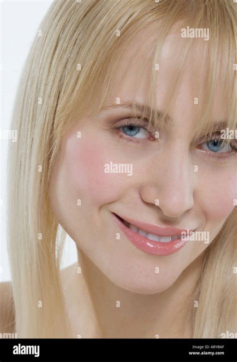 Headshot of woman with coy smile Stock Photo - Alamy