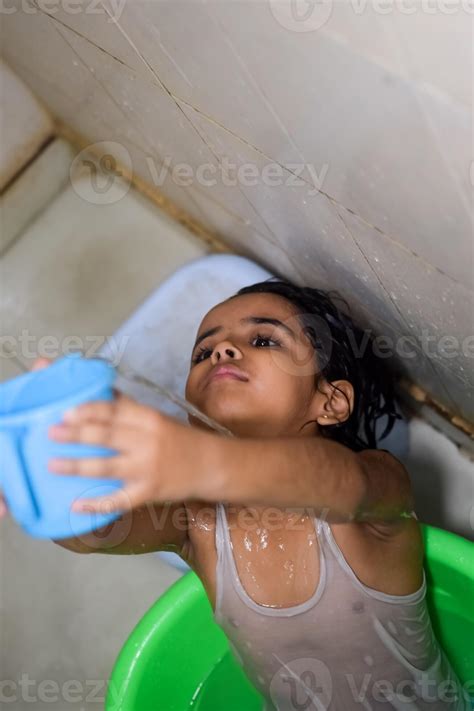 Cute Indian Girl having bath during the summer vacation season, Cute