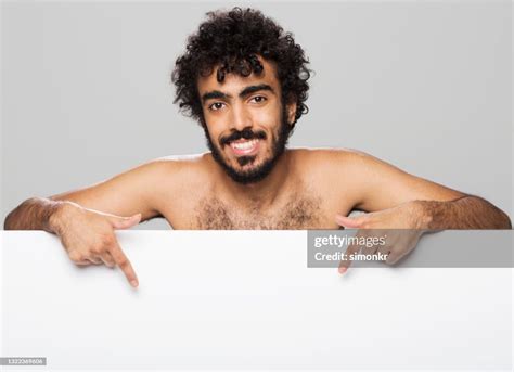smiling young man pointing  high res stock photo getty images