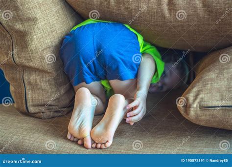 Rear View, Back Legs Feet of a Child Hiding Under a Pillow, Offended ...