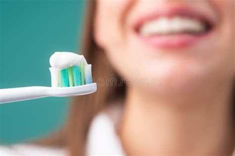 Toothbrush with Toothpaste. Closeup on Happy Young Woman Brushing Teeth ...