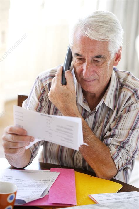 senior man checking paperwork stock image  science photo