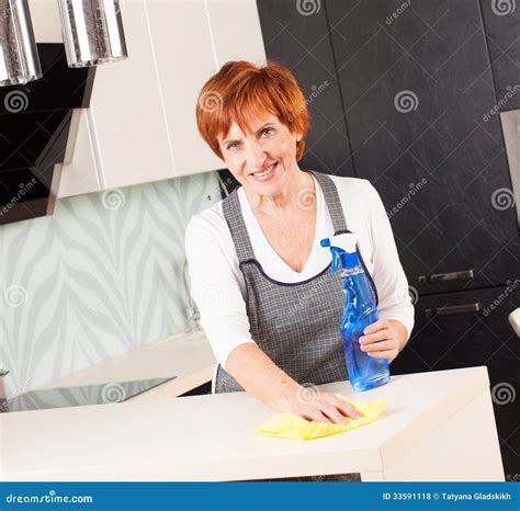 Female cleaning kitchen stock photo. Image of maid, mature - 33591118