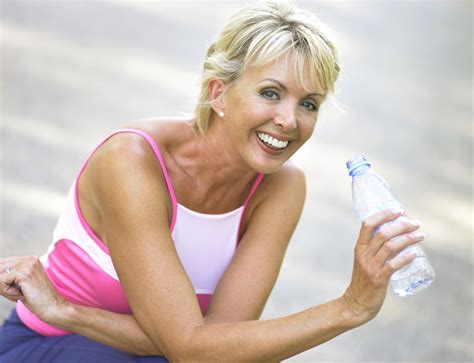 mature woman hydrating outdoors  photo  freeimages