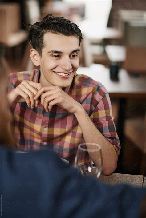 "Young Man Dining With Friends" by Stocksy Contributor "Clique Images