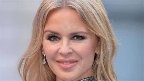 Kylie Minogue bewitches in billowing dress and knee-high leather boots ...
