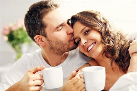 Young couple drinking coffee in bed 15884148 Stock Photo at Vecteezy