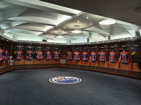 Mackenzie Weegar tries on his new Flames' jersey in the team locker