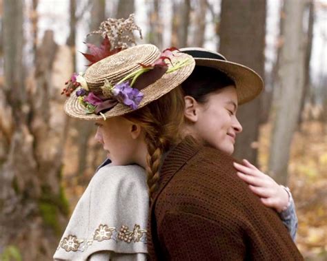 Download Two Girls In Hats Hugging In The Woods | Wallpapers.com