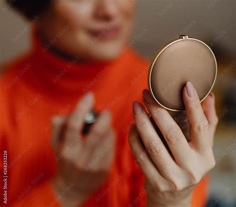 Woman putting on perfume Stock Photo | Adobe Stock