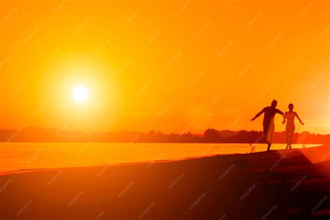 premium photo naked man   woman running   beach  sunset