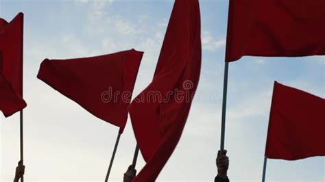 Hands of a Group of People Waving Red Flags Against Blue Sky Stock ...