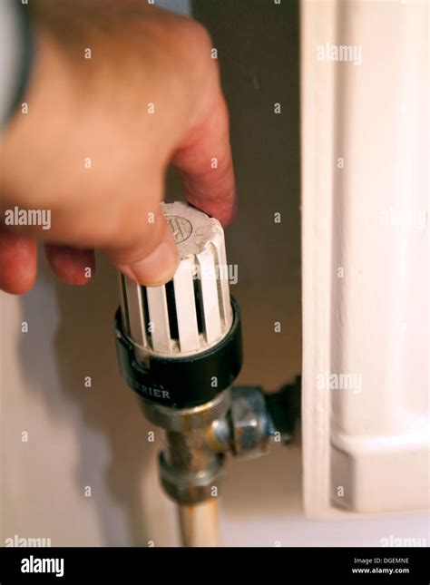 Adjusting thermostatic radiator valve, London Stock Photo - Alamy