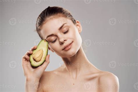 Beautiful brunette naked shoulders avocado in clean skin hand 22260788