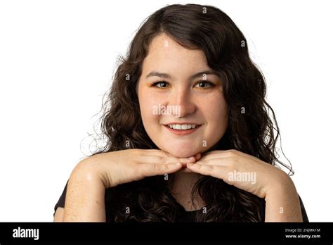 young woman smiles  camera  hands  chin  white background