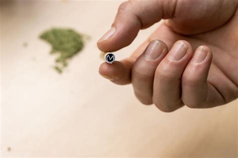 Premium Photo | A person39s hand holding a filter to assemble a marijuana joint