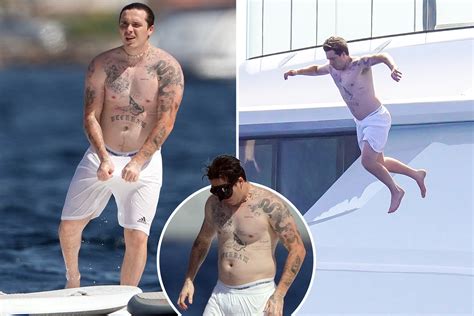 Brooklyn Beckham shows off HUGE tattoo collection as he jumps off a ...