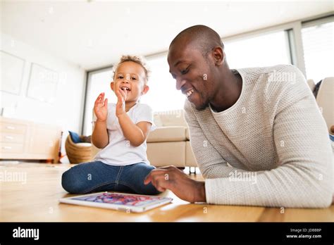 Afro-american father with little daughter with tablet at home Stock ...