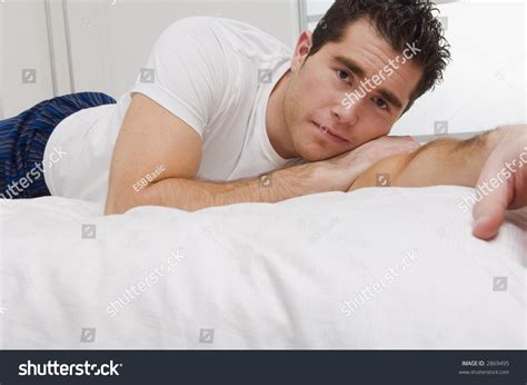 guy laying  bed stock photo  shutterstock