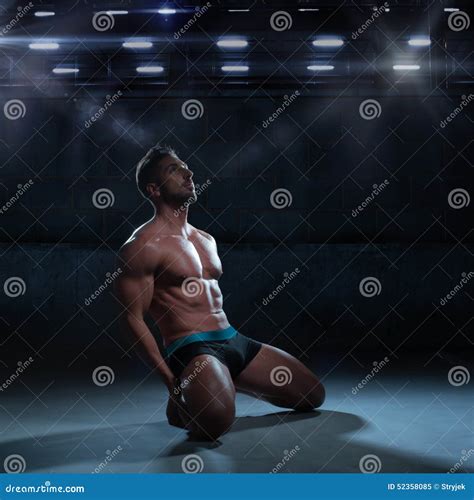 Thoughtful Athletic Man Kneeling On The Floor Stock Photo - Image: 52358085