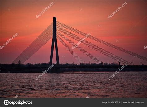 Bridge in sunset at Daugava river Riga — Stock Photo © vidarnm #321267610