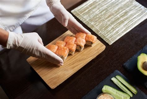Premium Photo | Close-up view of process of preparing rolling sushi ...