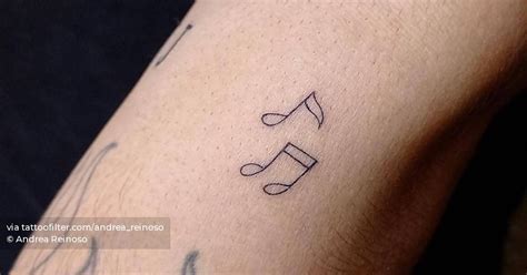 FIne line music notes tattoo located on the forearm.