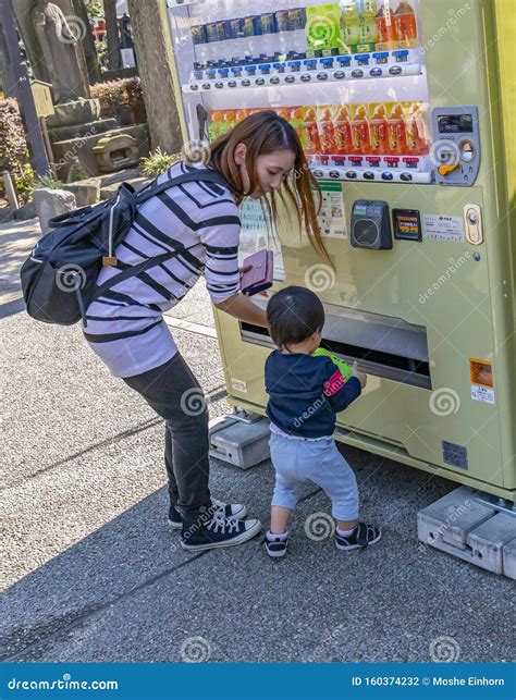 A Mother Buying a Drink for Her Son Editorial Photography - Image of