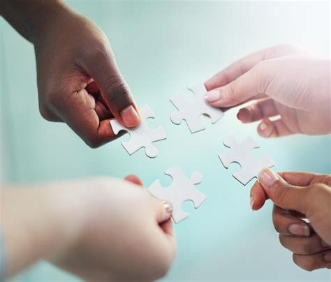 Premium Photo | They have it all figured out hands putting puzzle ...