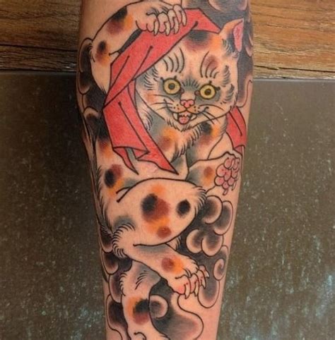 Coloured spotted playing cat tattoo - Tattooimages.biz